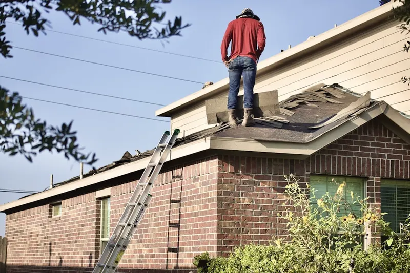 Professional roofer working on a residential roof in Downtown Fayetteville